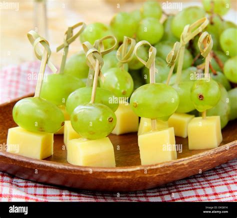 canape snack - cheese with green grapes on wooden skewers Stock Photo - Alamy