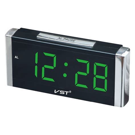 an alarm clock with green numbers on the front and back sides, showing the time