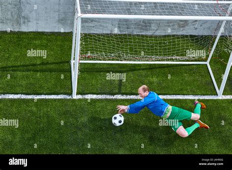 Soccer football goalkeeper making diving save Stock Photo - Alamy