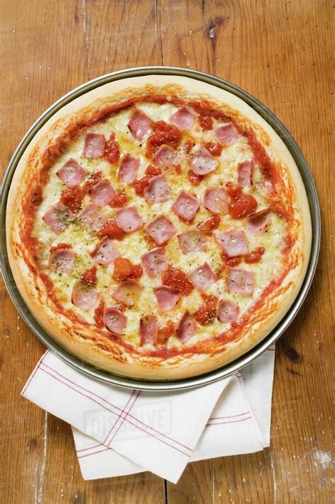 Ham, cheese and tomato pizza - Stock Photo - Dissolve