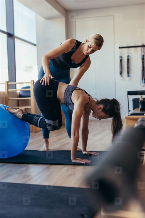 Pilates woman training with an exercise ball at gym stock photo (150481) - YouWorkForThem