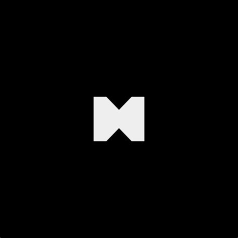 the letter m is made up of two white letters on a black background, and it appears to be folded ...