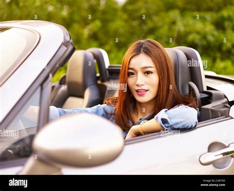 young asian woman riding in a convertible sports car Stock Photo - Alamy