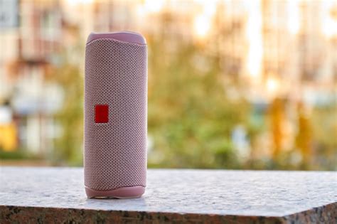 Premium Photo | Portable pink wireless speaker in the city on granite surface