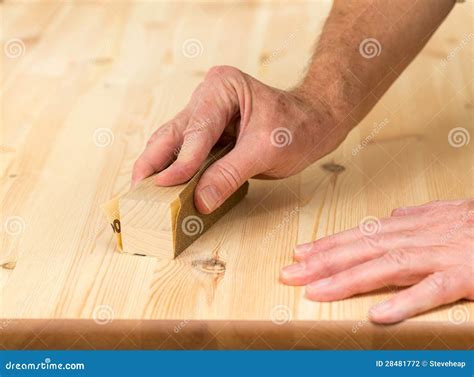 Mans Hand On Sanding Block On Pine Wood Stock Photography - Image: 28481772