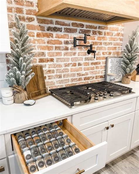 White Kitchen with Brick Wall Behind Stove - Soul & Lane