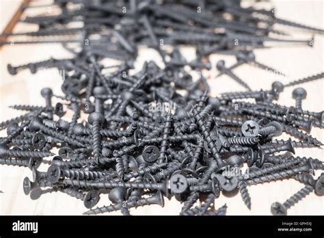 A lot of black metal screws on the surface Stock Photo - Alamy