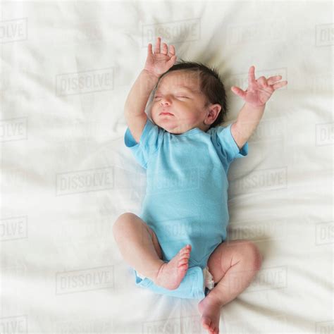 Portrait of newborn baby boy (0-1 months) sleeping - Stock Photo - Dissolve