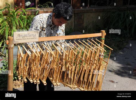 Man playing the Angklung instrument from Indonesia Stock Photo - Alamy