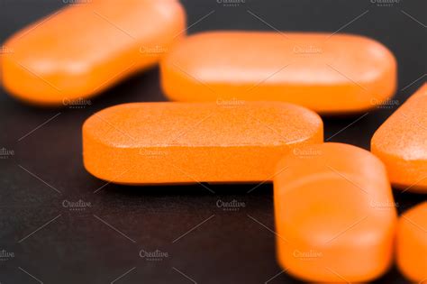 a long orange pill ~ Health Photos ~ Creative Market