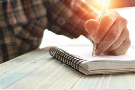 Person writing in a journal 1964596 Stock Photo at Vecteezy