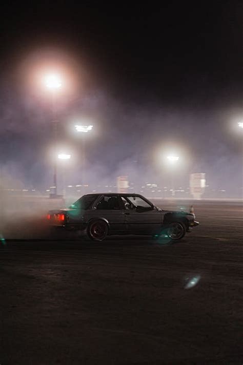 A Black Car on the Road at Night · Free Stock Photo