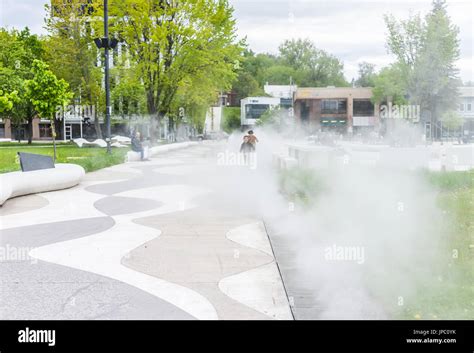 Saguenay, Canada - June 3, 2017: Kids running in mist fog steam water ...