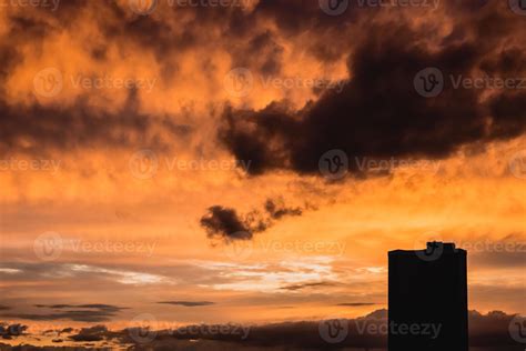 Dramatic orange sunset with building silhouette 8988928 Stock Photo at Vecteezy