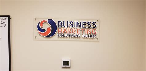 Company logo printed and applied to clear acrylic and mounted to the wall right as you walk in ...