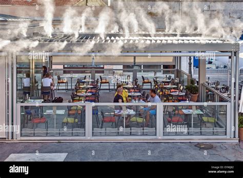 Pula, Croatia. An open-air restaurant using a water mist cooling system in summer, when 40 ...