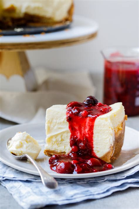 Classic lemon cheesecake with easy berry sauce - Simply Delicious