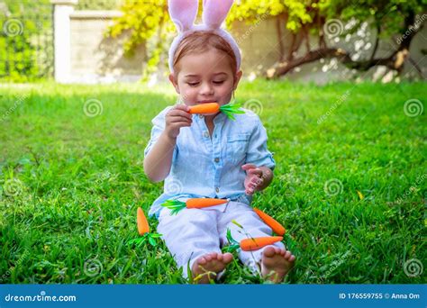 Easter Baby Bunny Eating Carrot Stock Image - Image of lawn, children ...