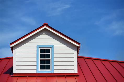 24417798 - close up a red roof detail house and a blue sky - Mullins ...