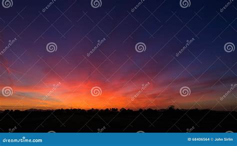 Dramatic Red and Orange Sunset Sky with Tree Silhouettes Stock Photo ...