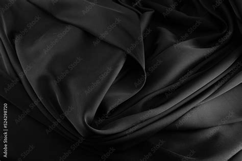 Folds of black silk fabric. Stock Photo | Adobe Stock