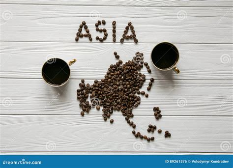 Map of the Asia Made of Roasted Coffee Beans Laying on White Wooden Textured Background with Two ...