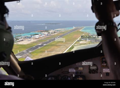 Aircraft cockpit. View on Male airport and takeoff airplane Stock Photo - Alamy