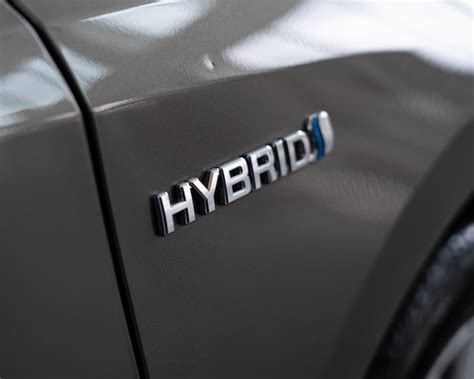 Premium Photo | Hybrid car logo on the back side of automobile