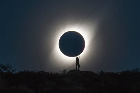 Photographer Captures Perfect Shot of Person 'Holding' the Total Solar Eclipse | PetaPixel