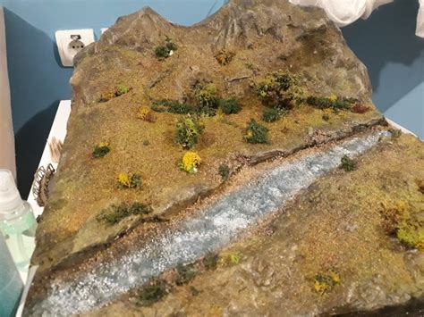 Realistic landscape diorama Stones added in the river and first addition of grass and bushes ...