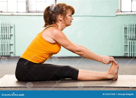 Mature Woman Exercising Yoga Stock Photo - Image: 26321040