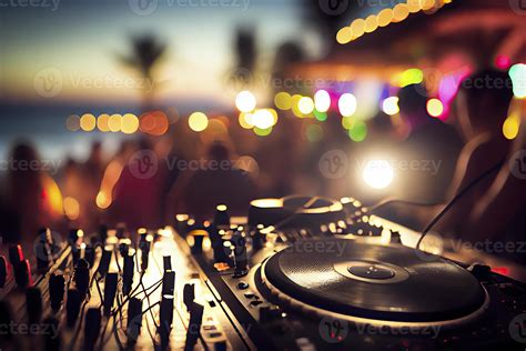 Dj mixing outdoor at beach party festival with crowd of people in ...