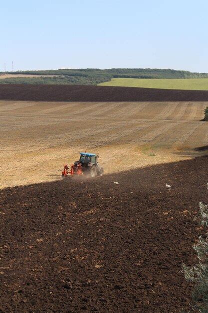 Premium Photo | A tractor plowing a field