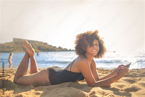 Girl lying down at the beach Stock Photo | Adobe Stock