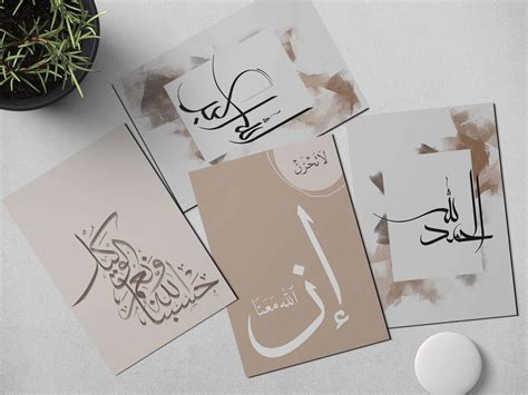 arabic calligraphy on various cards next to a potted plant and computer mouse,