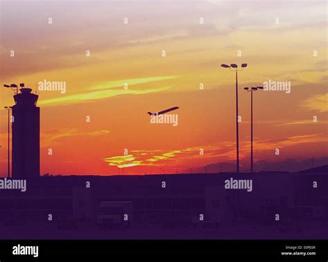 Plane taking off at sunset Stock Photo - Alamy