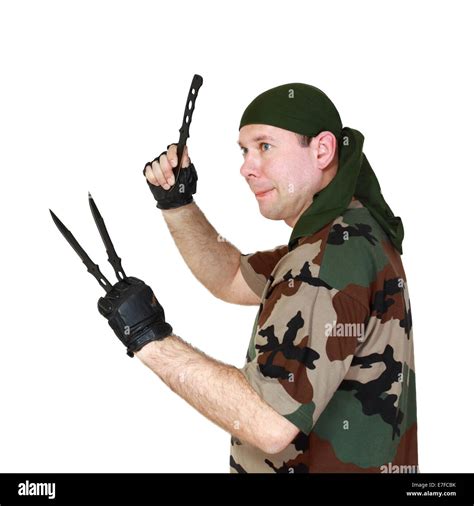 Man in camouflage throw knives. Isolated on white background Stock Photo - Alamy