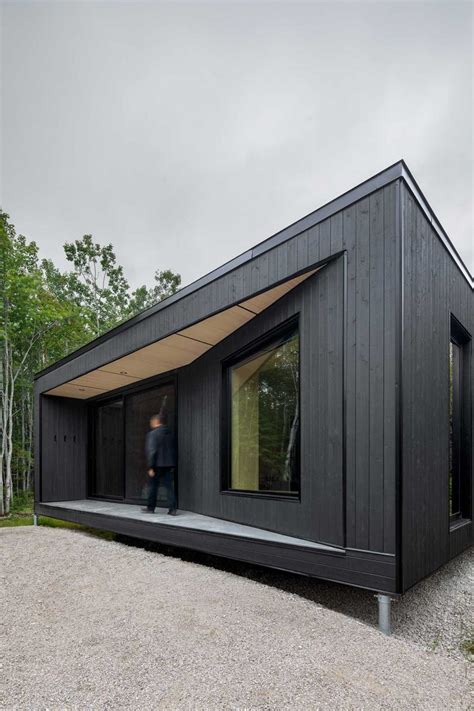 A Compact, Modern Cabin in the Woods That Reflects the Trees