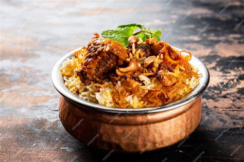 Premium Photo | Mutton Biryani served in a golden dish isolated on dark background side view ...