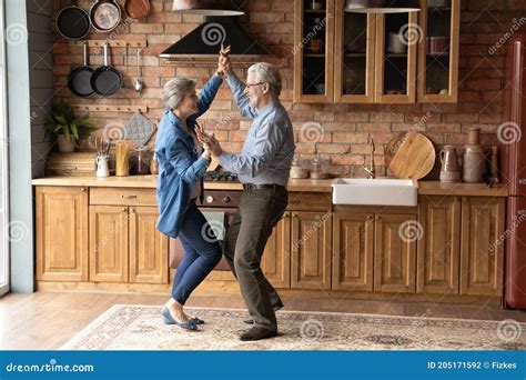 Energetic Middle Aged Family Couple Dancing in Kitchen. Stock Photo - Image of happy, family ...