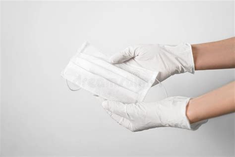 Hand with a Medical Face Mask and Medical Gloves for Protection Against Coronavirus Covid-19 ...