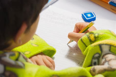 A boy is doing his homework, writing a book 9309814 Stock Photo at Vecteezy