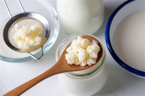 Premium Photo | Kefir fermented milk drink with kefir grains Homemade kefir stands in a glass ...