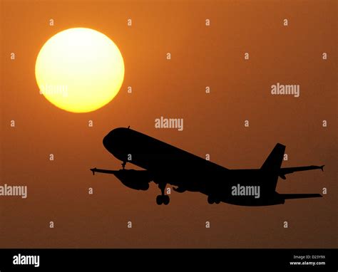 Plane taking off into the sunset Stock Photo - Alamy