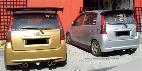 two small cars parked next to each other in front of a red and yellow ...