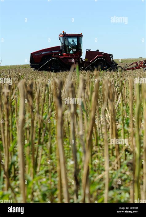 Tractor plowing field Stock Photo - Alamy