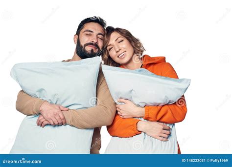 Couple in Home Clothes Hugging Pillows Stock Image - Image of dreamy, care: 148222031