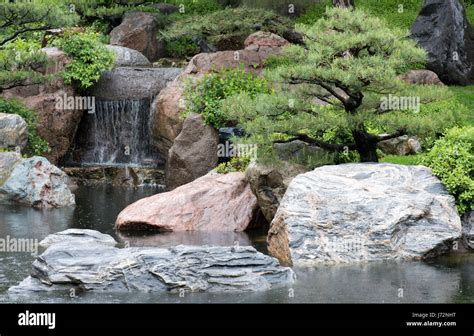 Waterfall in a pond in a Japanese garden Stock Photo - Alamy