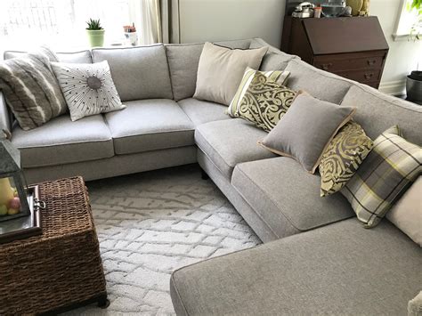 Grey sectional sofa with light green accents in family room | White walls living room, Small ...