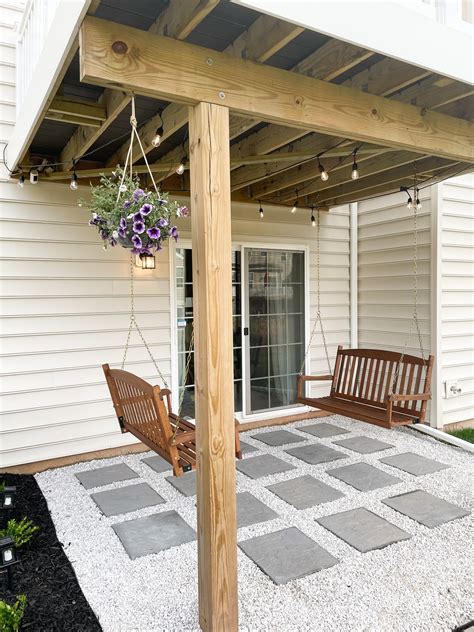 DIY PAVER AND MARBLE GRAVEL PATIO WITH MULCH BEDS & PORCH SWINGS | A Classy Fashionista